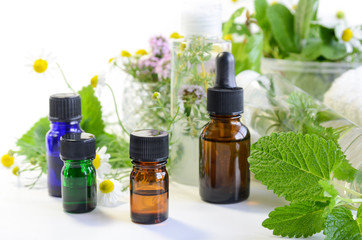 essential oils with herbal cosmetics and fresh herbs