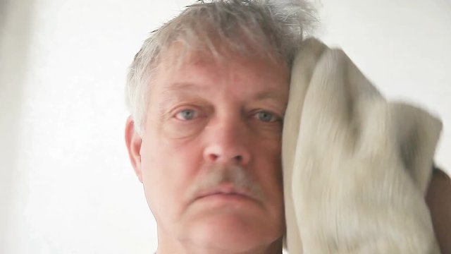 Older Man Drying Hair After Shower