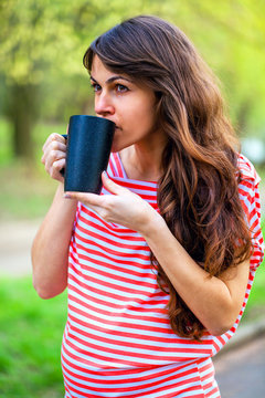 girl drinking coffee at the park