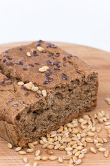 Chrono bread on a wooden board with grains of wheat