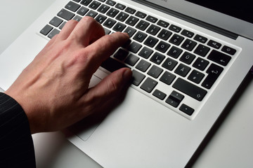 typing on laptop computer