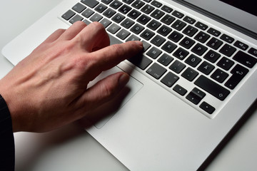 typing on laptop computer