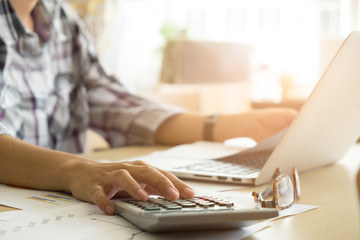 hand of accountant analyzing bussiness and finance and stock report