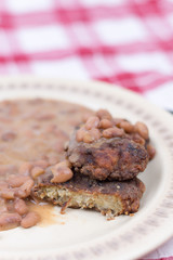 Sliced meatballs on the plate with cooked beans