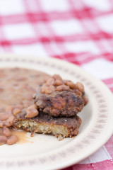 Sliced meatballs on the plate with cooked beans