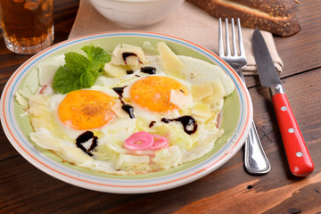 Dish with fried eggs boundary and aromas