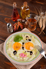 Dish with fried eggs boundary and aromas