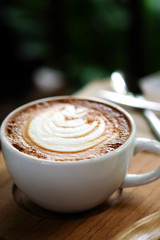 Hot coffee on a wooden  table.