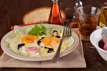 Dish with fried eggs boundary and aromas
