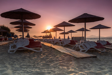 Sunset on the beach with umbrellas - 109327928