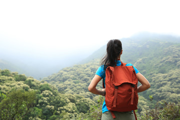 young  woman hiker enjoy the view on mountain peak