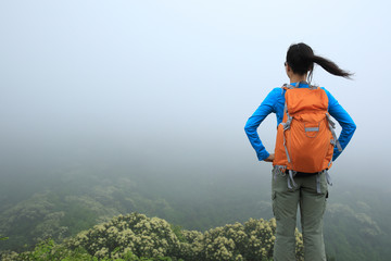 young  woman hiker enjoy the view on mountain peak