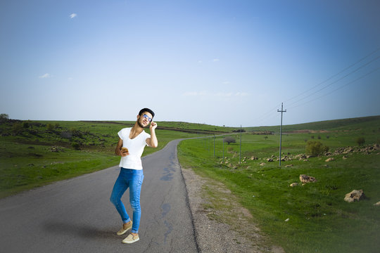 Brunette boy standing on paved street in Iraqi countryside