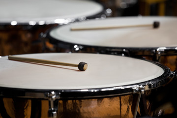  Drumsticks lying on timpani closeup 