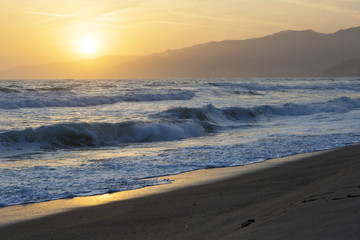 The Pacific ocean during sunset. Landscape with blue sea, the mountains and the dusk sky, the USA, Santa Monica. 