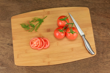tomato dill with herbs for the preservation on old wooden table.