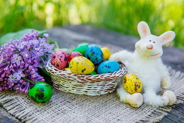 painted Easter eggs with bunny on grass background