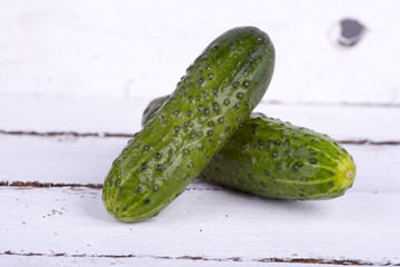green cucumber on old boards