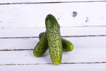 green cucumber on old boards