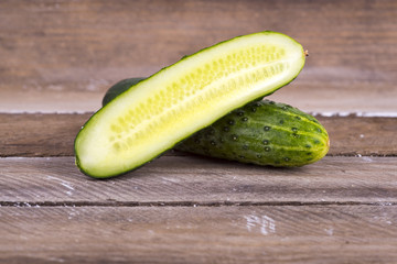 green cucumber on old boards