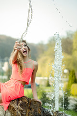 Happy woman near fountain