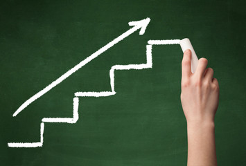 Hand drawing steps on blackboard
