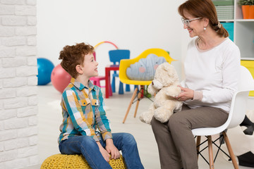 Therapist working with autistic kid
