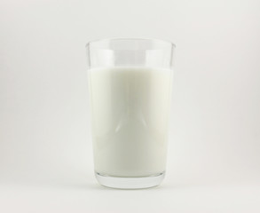 The glass of milk on white background