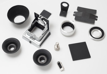 Set of spare parts for antique old medium format camera on white, eyepiece, viewfinder