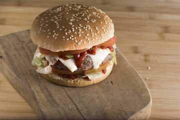 hamburger on cutting board. homemade sandwich with cheese,