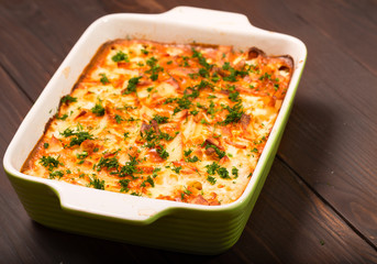 Dish with the baked potatoes on a kitchen table