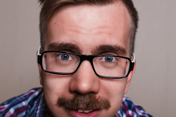 close up portrait of hipster. kind person wath into camera. big face with glasses and beard