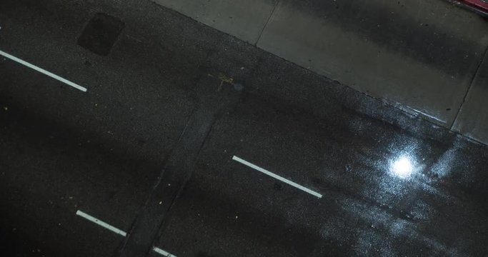 LOS ANGELES, CA, USA  - FEBRUARY 2016:  Time lapse with cars and other vehicles in Downtown LA in the rain. Slow shutter creates light trails.  Overhead view. Loopable clip.