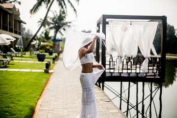 portrait of beautiful girl in white clothes dancing a beautiful dance mandala