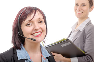 Close-up portrait of smiling young woman with headset