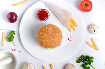 Burger topped with vegetables, spices and fries