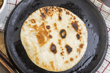 Flour tortilla cooked on cast iron skillet