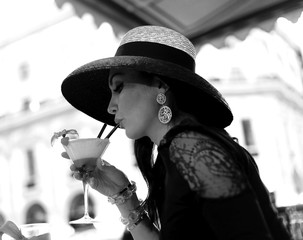 Beautiful vintage portrait of woman drinking cocktail black and white