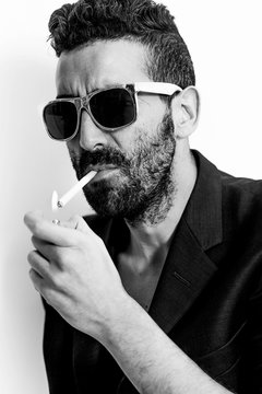 Handsome man portrait lightning cigarette black and white