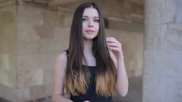 young sexy girl with long hair and big lips smiling in front of camera