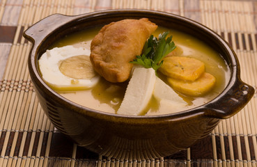 Elegant table setting with full serving of traditional fanesca soup and accessories