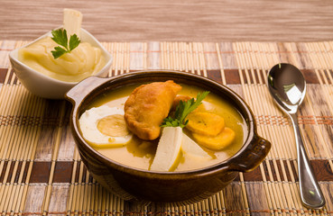 Elegant table setting with full serving of traditional fanesca soup and accessories