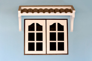 windows of house on blue wall.