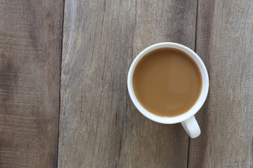 White coffee cup placed on the old wooden floor.