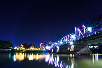 Fototapeta na wymiar Iron bridge At night Chiangmai in Thailand , With Lens Flare