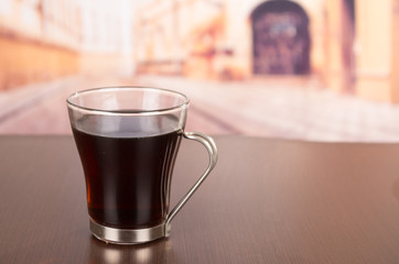 Delicious, fragant and bitter cup of coffee served on a wooden table