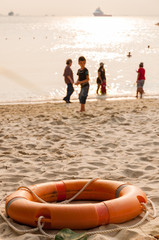 orange life buoy on beach