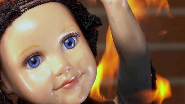 Baby doll on fire, burning and melting in normal speed.  High speed version also available.
