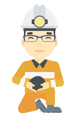 Miner holding coal in hands.