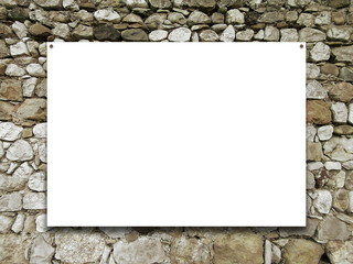 Close-up of one nailed blank poster frame on irregular stone wall background